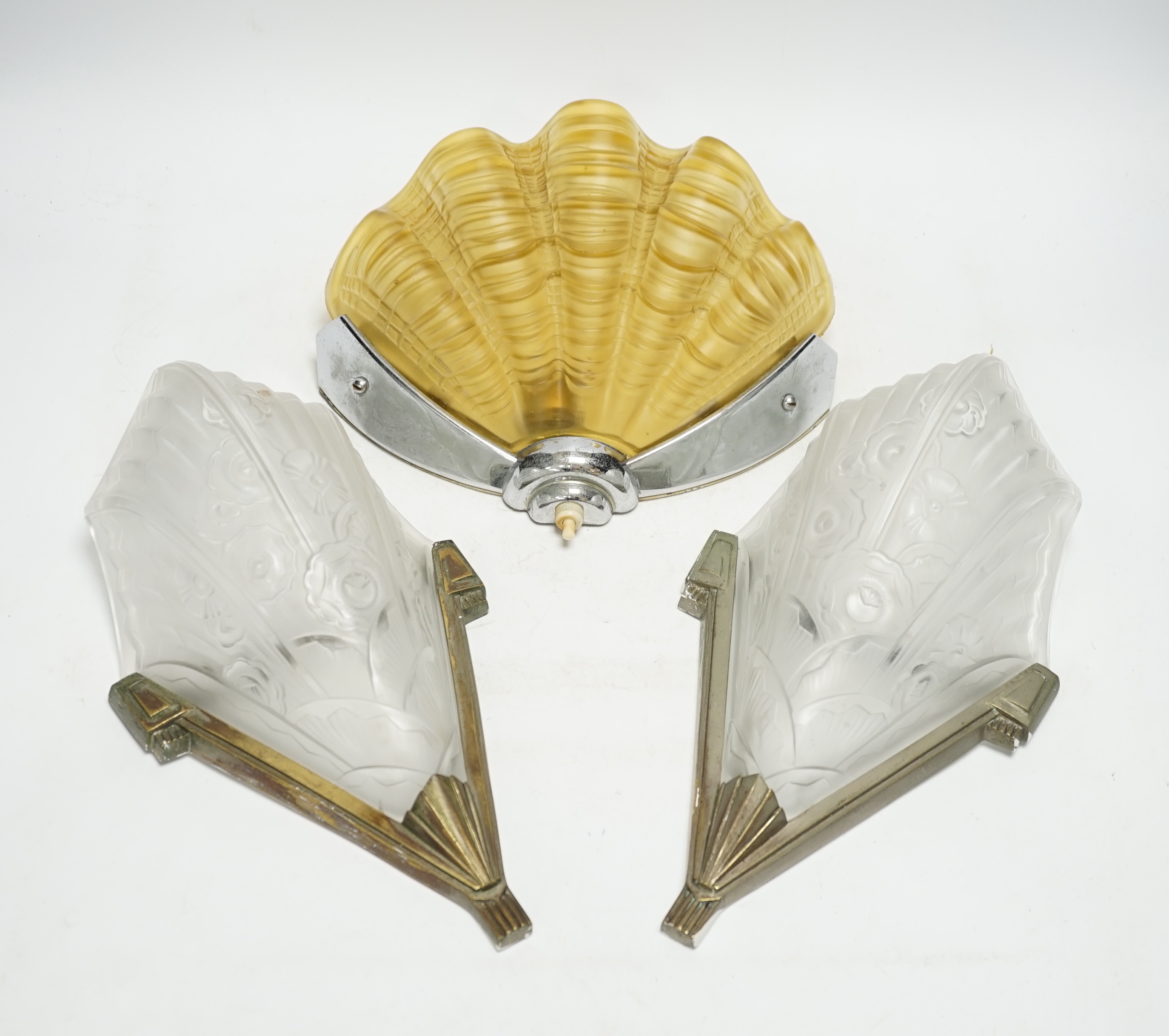 An Art Deco clam shell wall light and a pair of Art Deco wall lights, 30cm high (3). Condition - fair